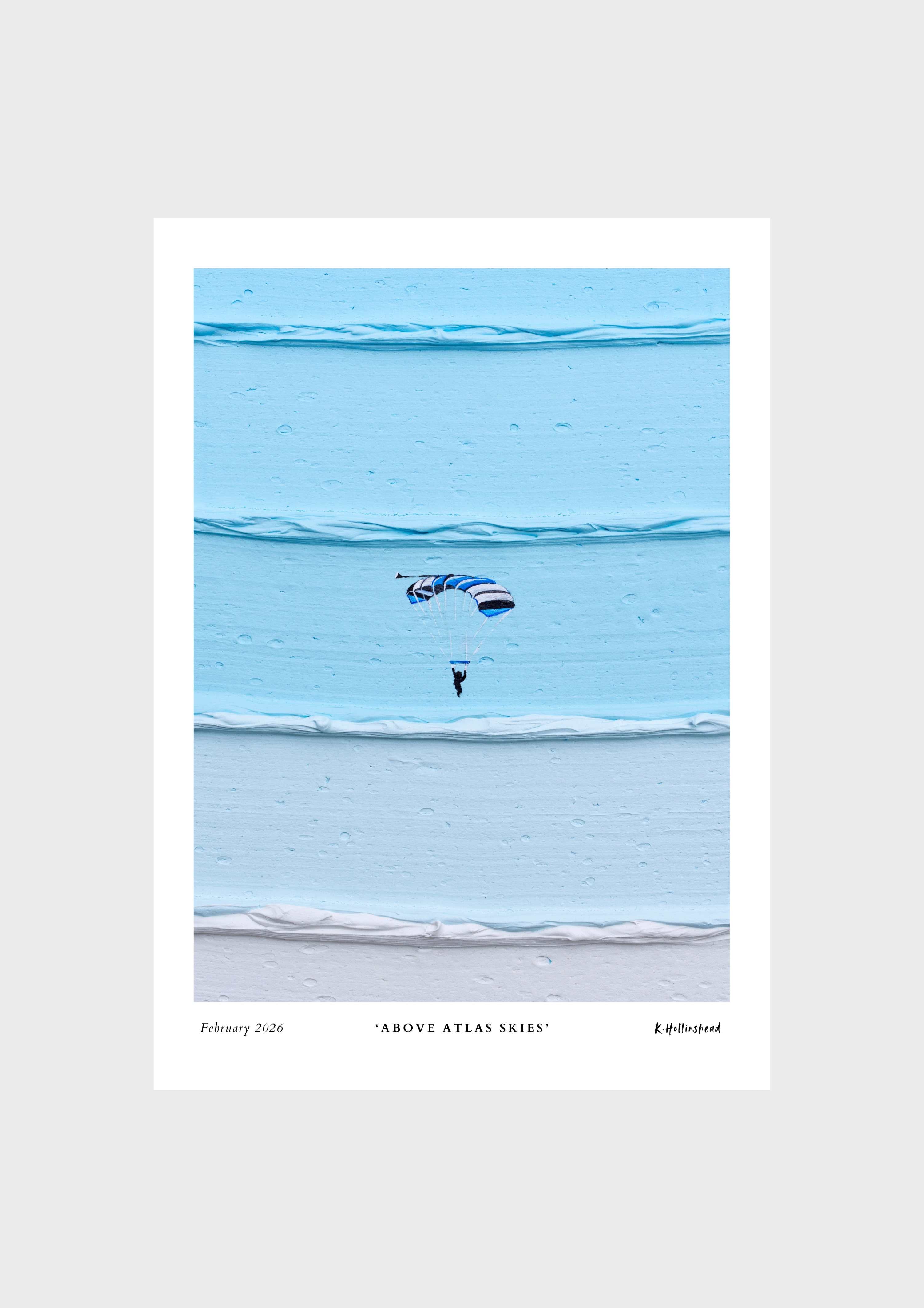 A minimalist art print titled 'Above Atlas Skies' featuring a small skydiver under a blue and white parachute against layered light blue water, presented on a light gray background.