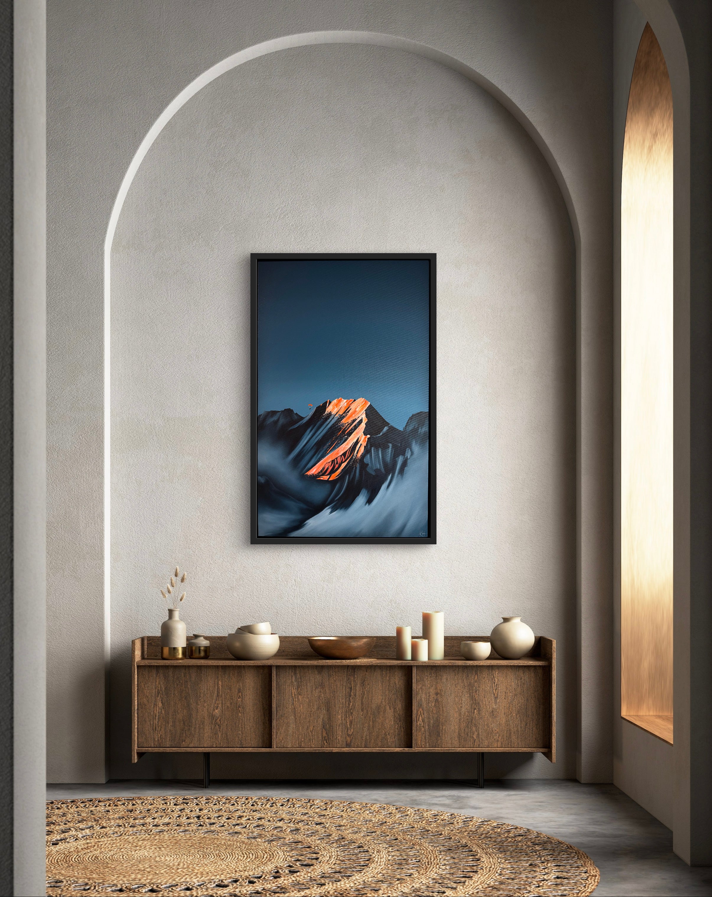Framed mountain BASE jump artwork on a wall.